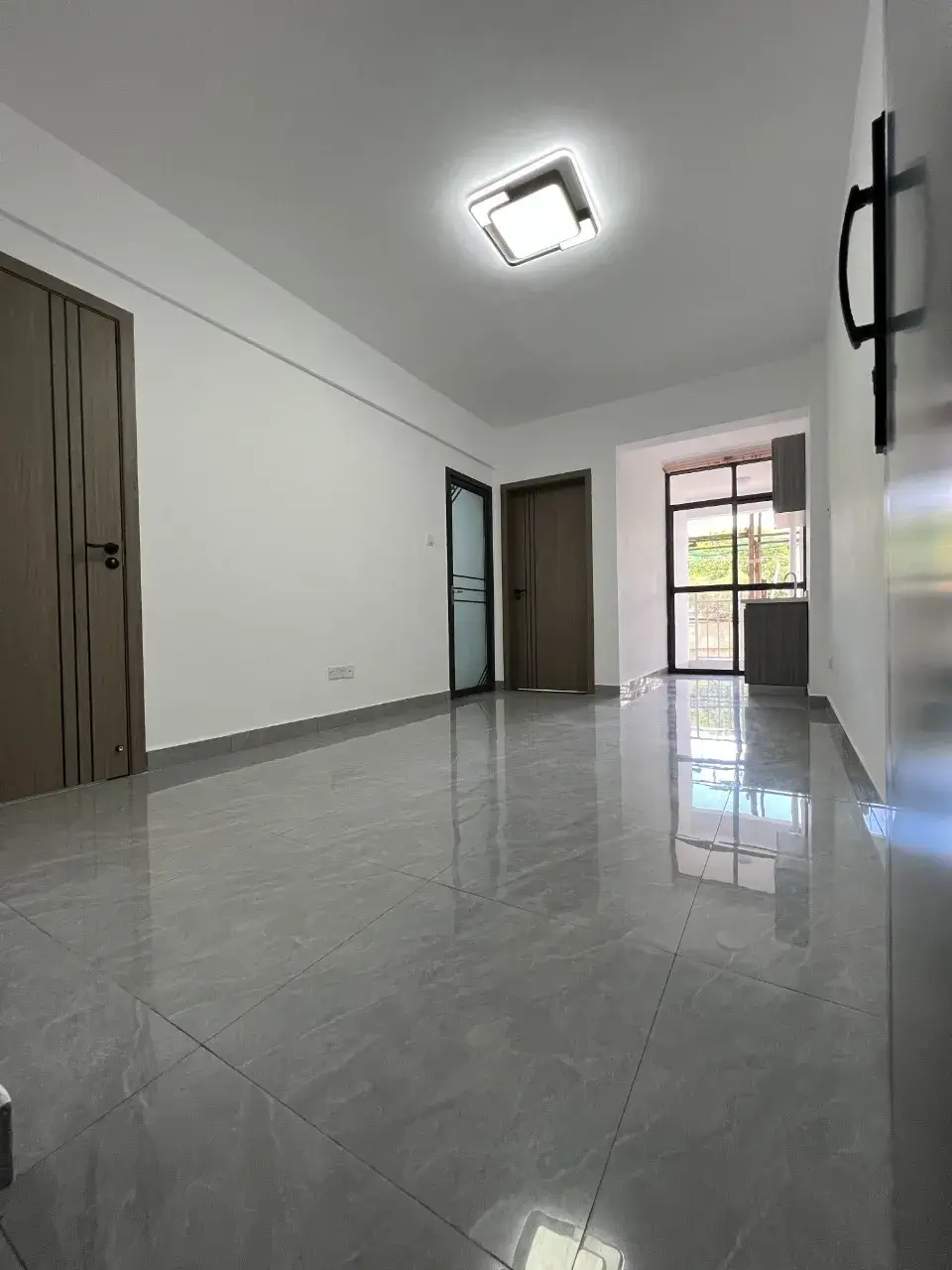 Bright, spacious hallway with polished tile flooring and natural light