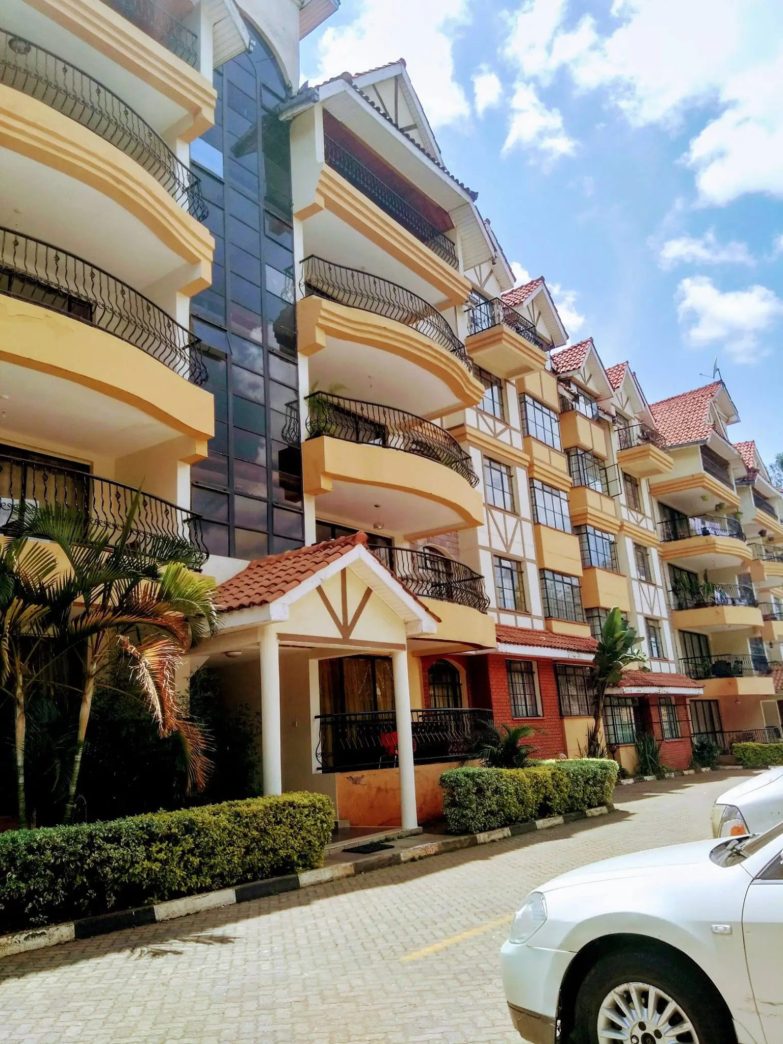 Multi-story residential building with yellow facade and balconies