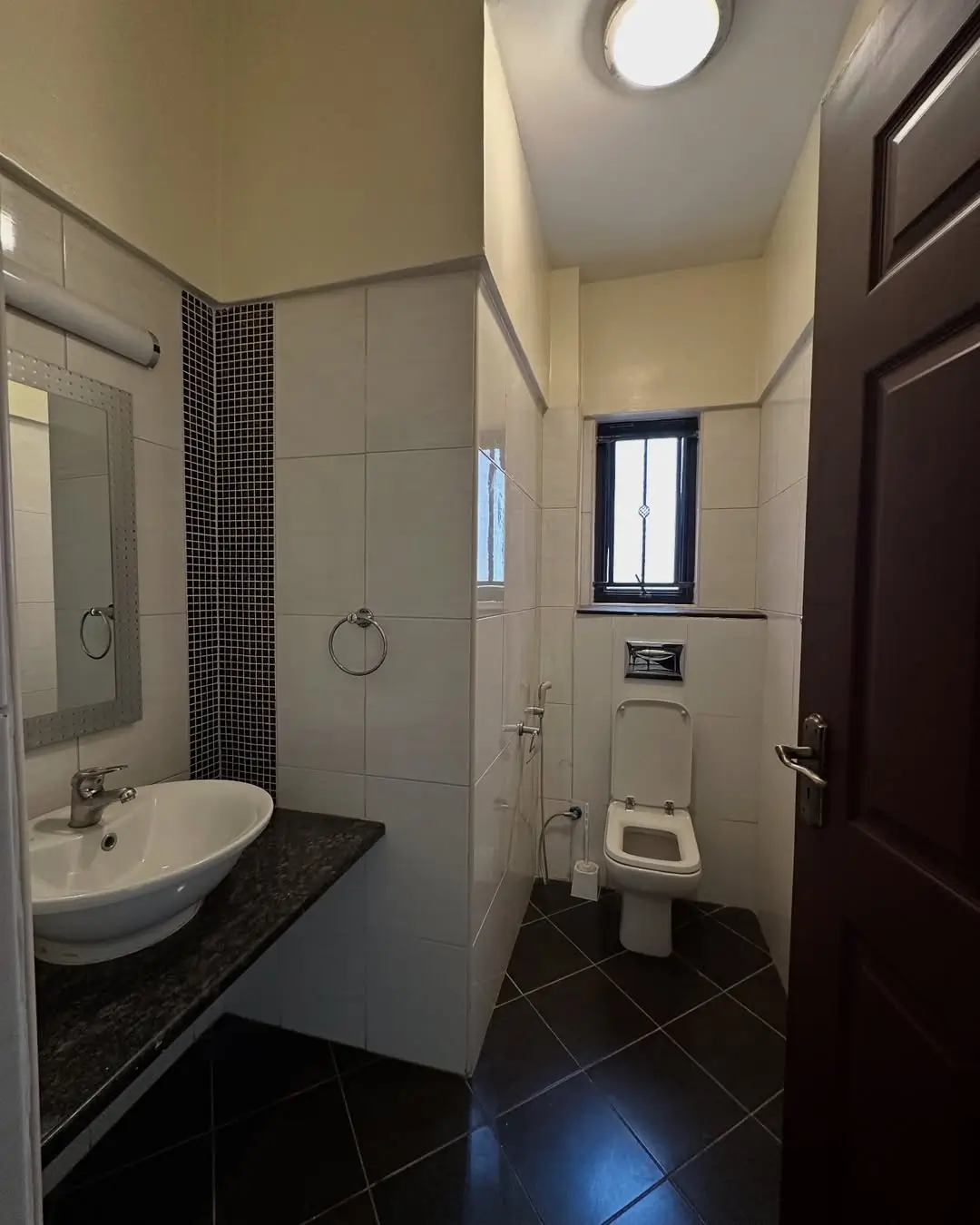 Modern bathroom with vessel sink, walk-in shower, toilet