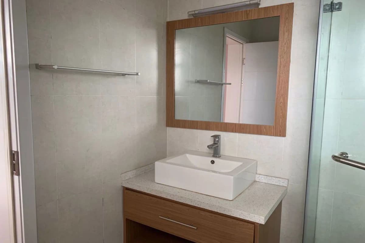 Modern bathroom with vessel sink and wooden vanity mirror