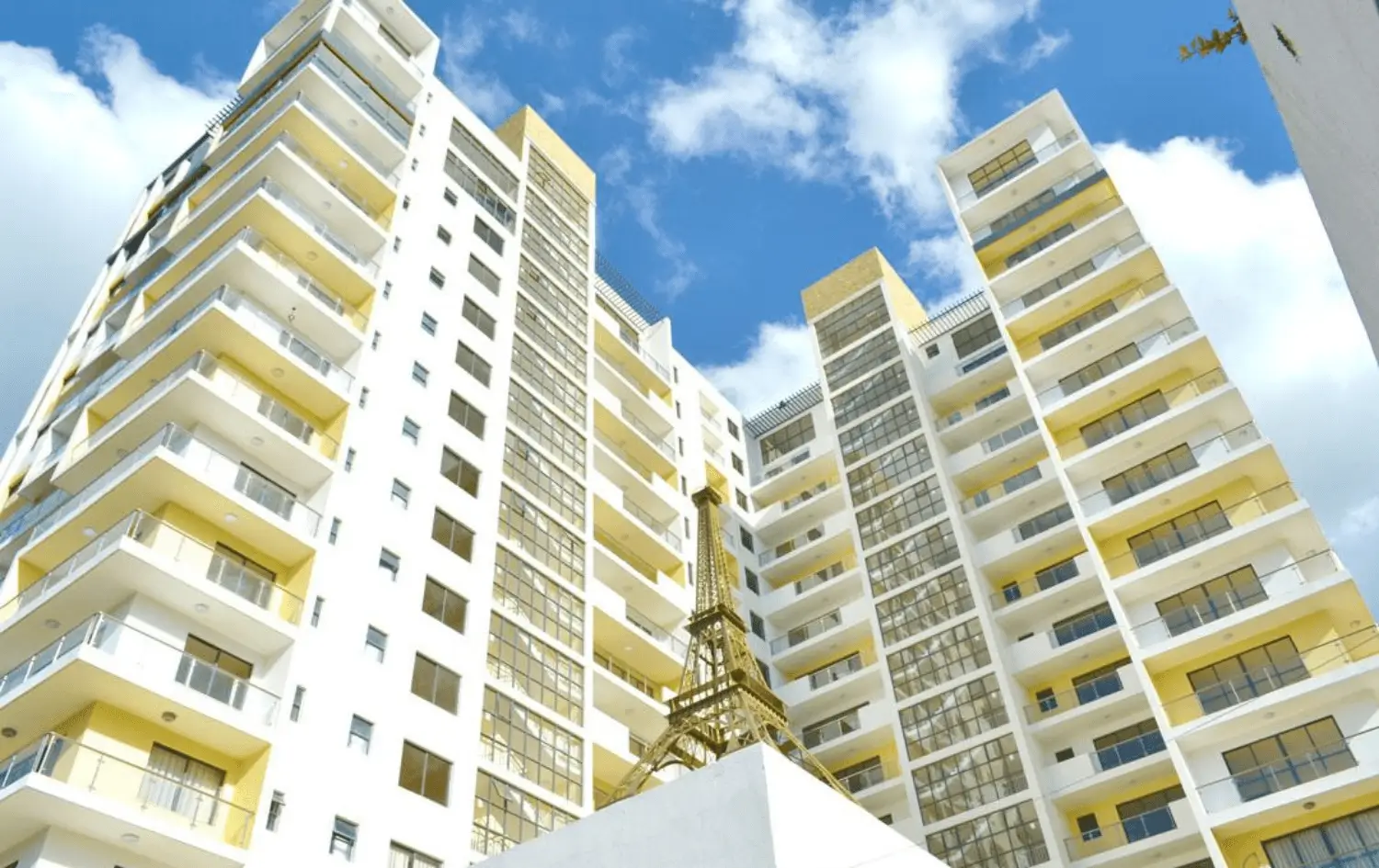 Modern multi-story residential building with yellow balconies