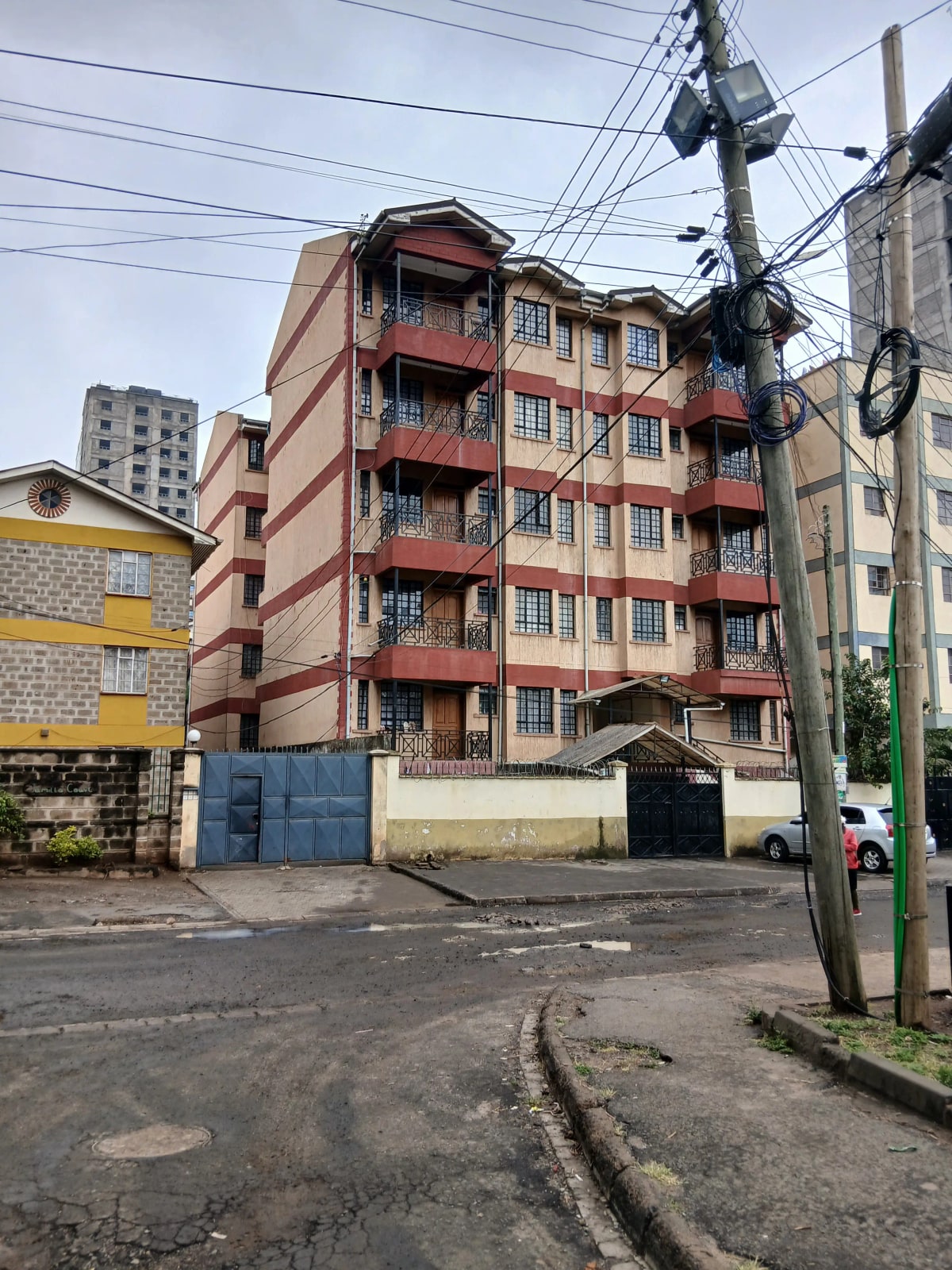 Multi-story residential building facade with red brick exterior