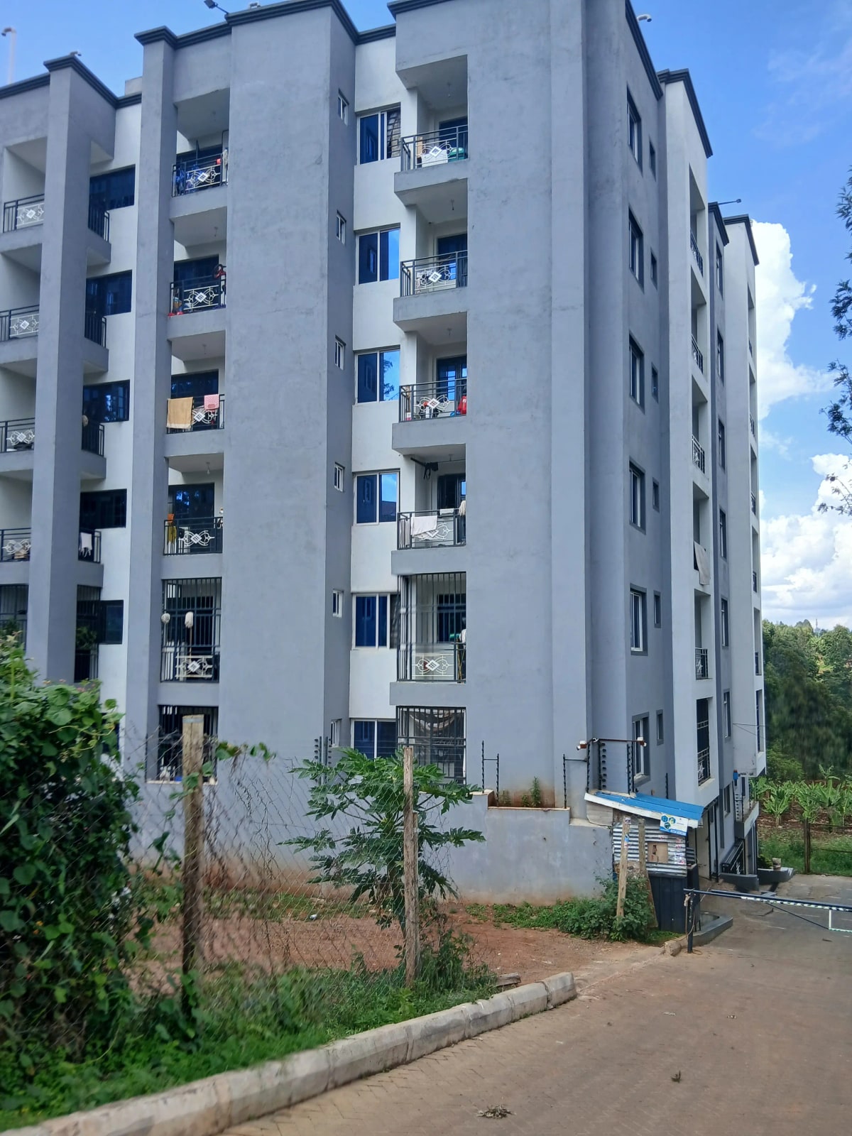 Modern multi-story apartment building with balconies and landscaping