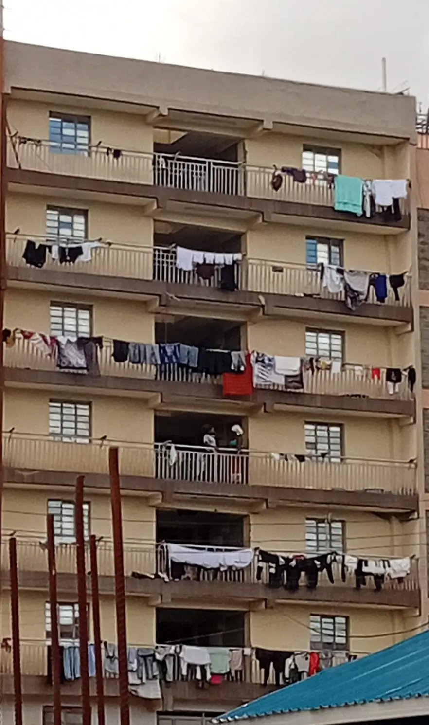 Multi-story residential building facade with clotheslines on balconies