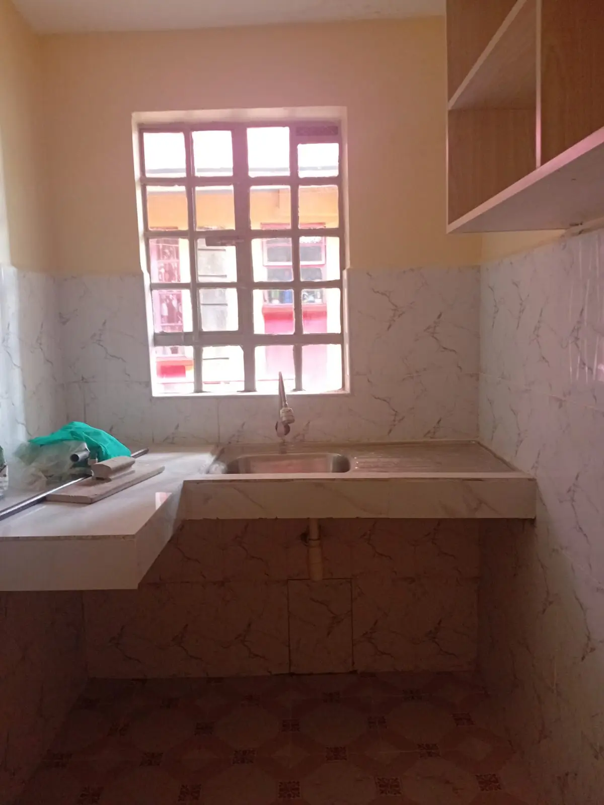 Compact kitchen with sink, counter, and large window