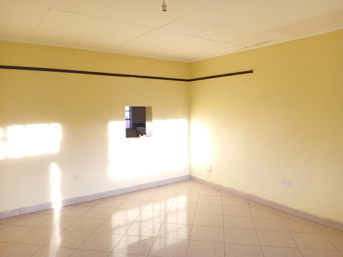 Bright empty living room with yellow walls and natural light