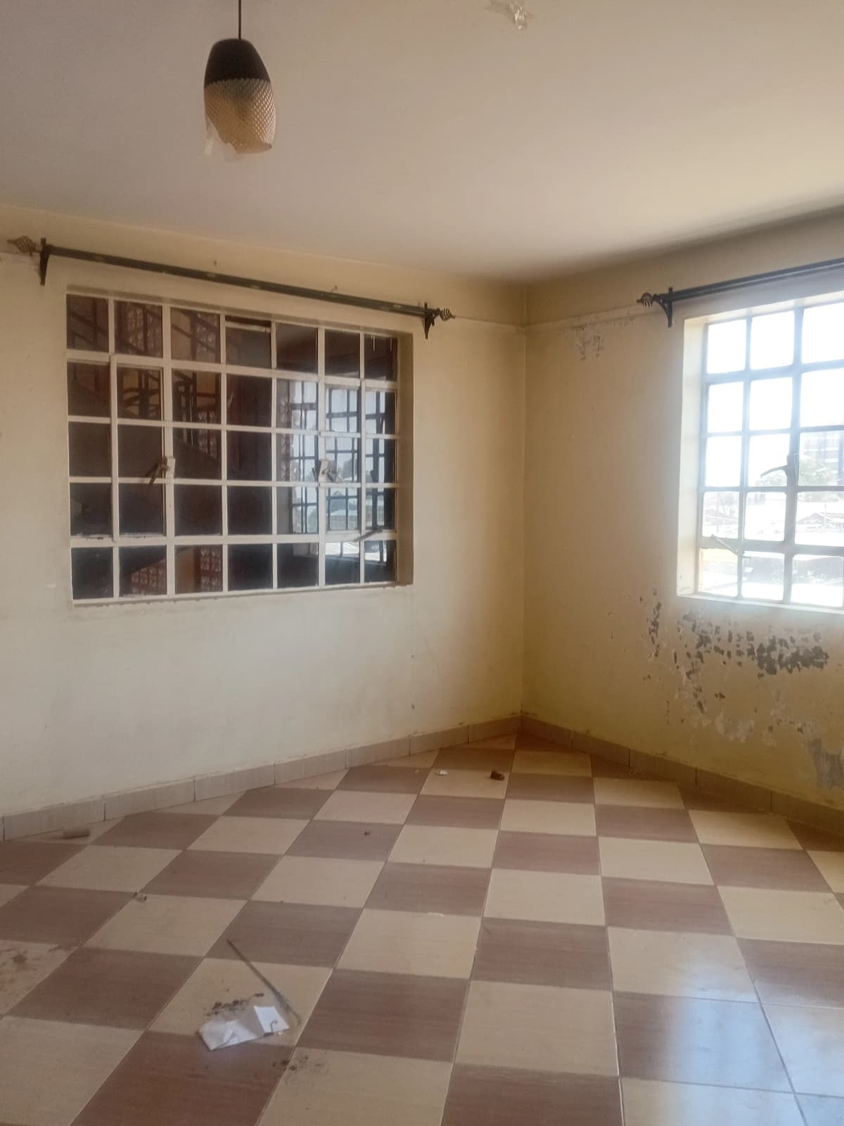 Empty kitchen with checkered floor and window light