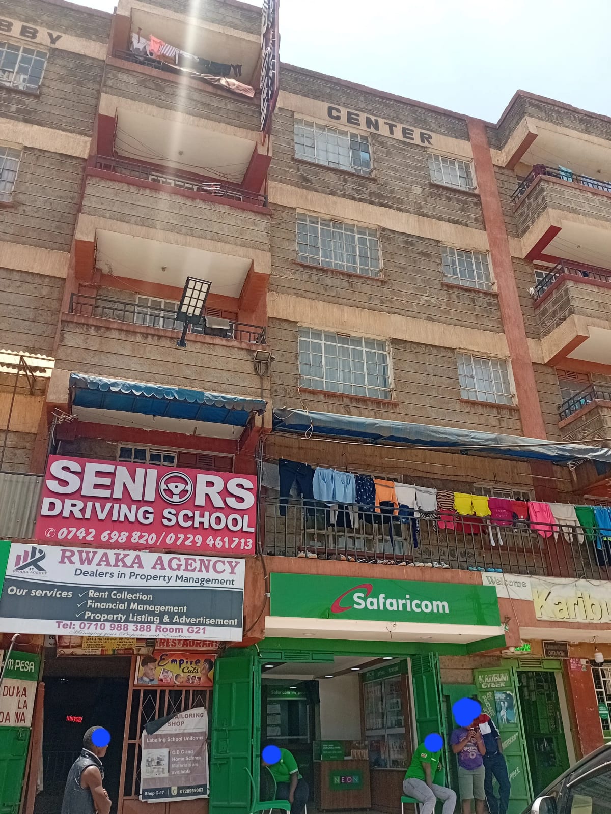 Multi-story residential building facade with ground-floor commercial units