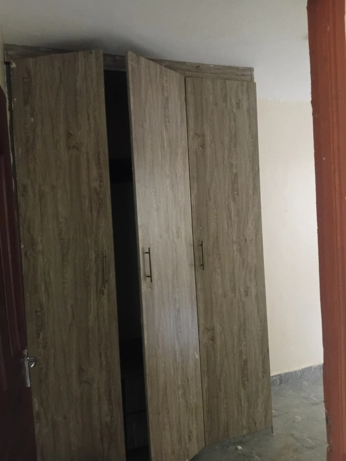 Wooden built-in wardrobes in neutral bedroom space