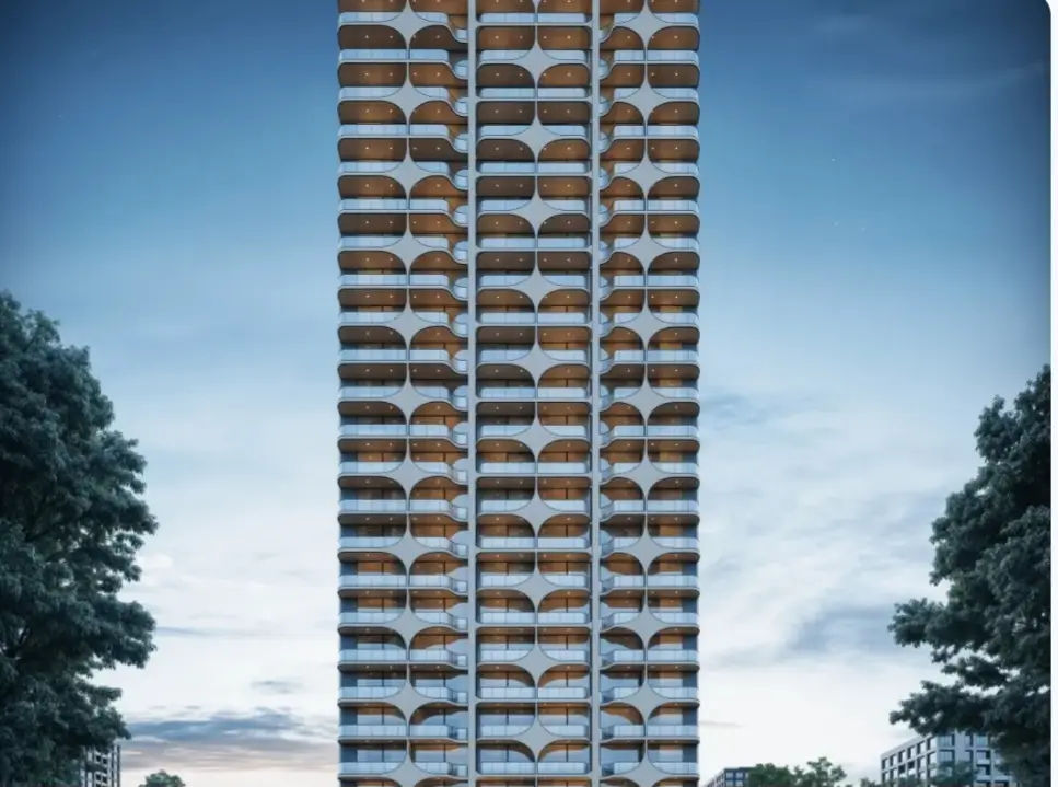 Tall modern high-rise tower with curved balcony facade