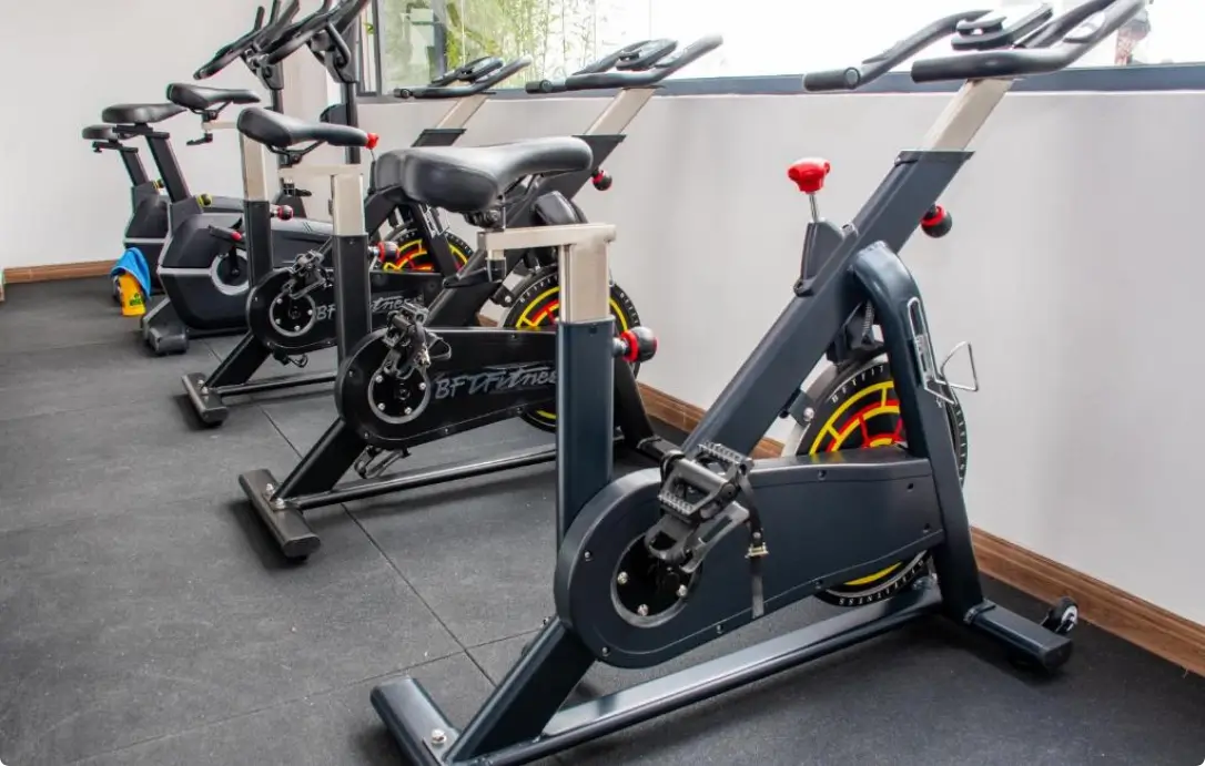 Professional indoor gym with multiple stationary cycling bikes