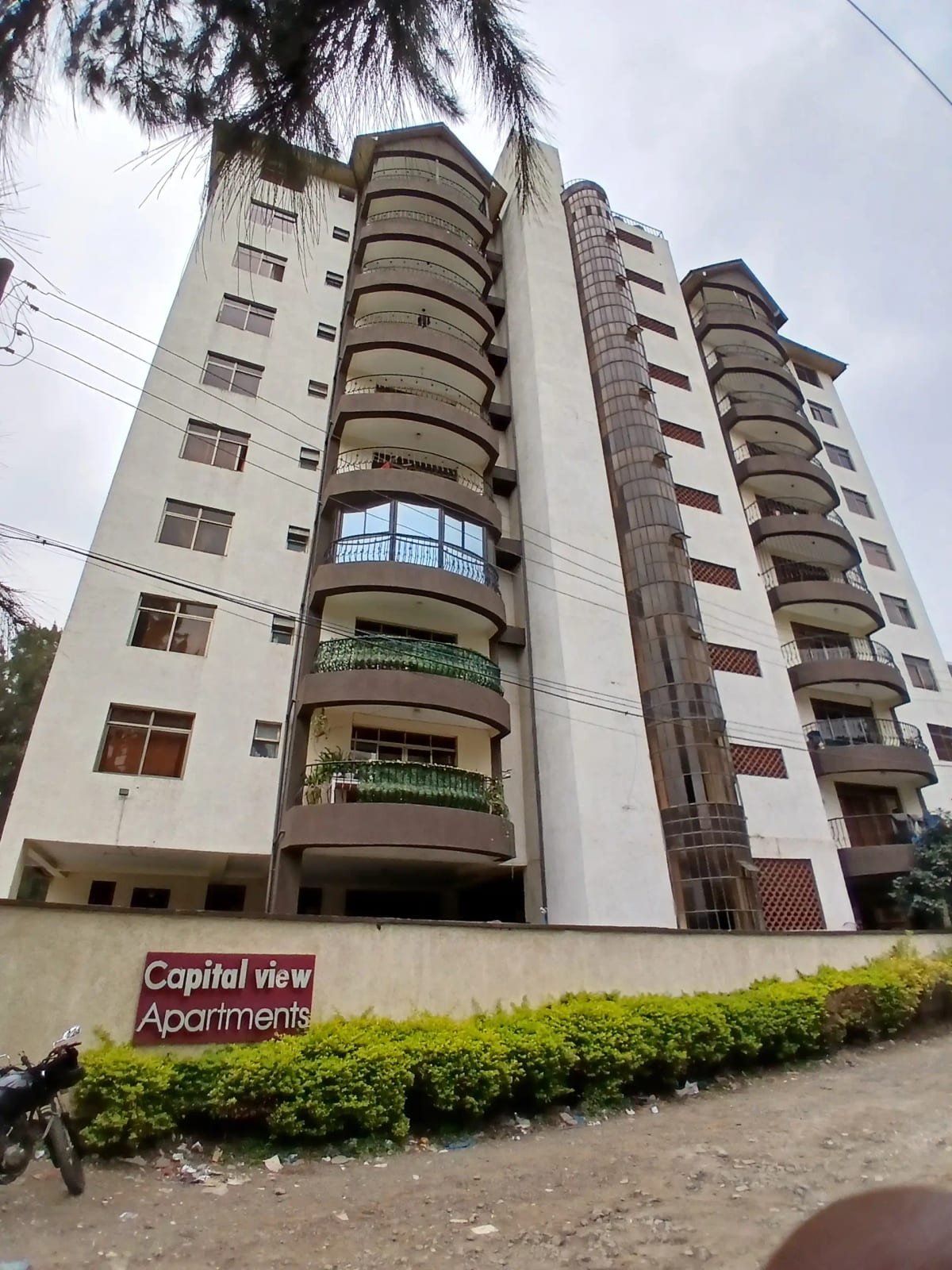 Multi-story apartment building facade with curved balconies