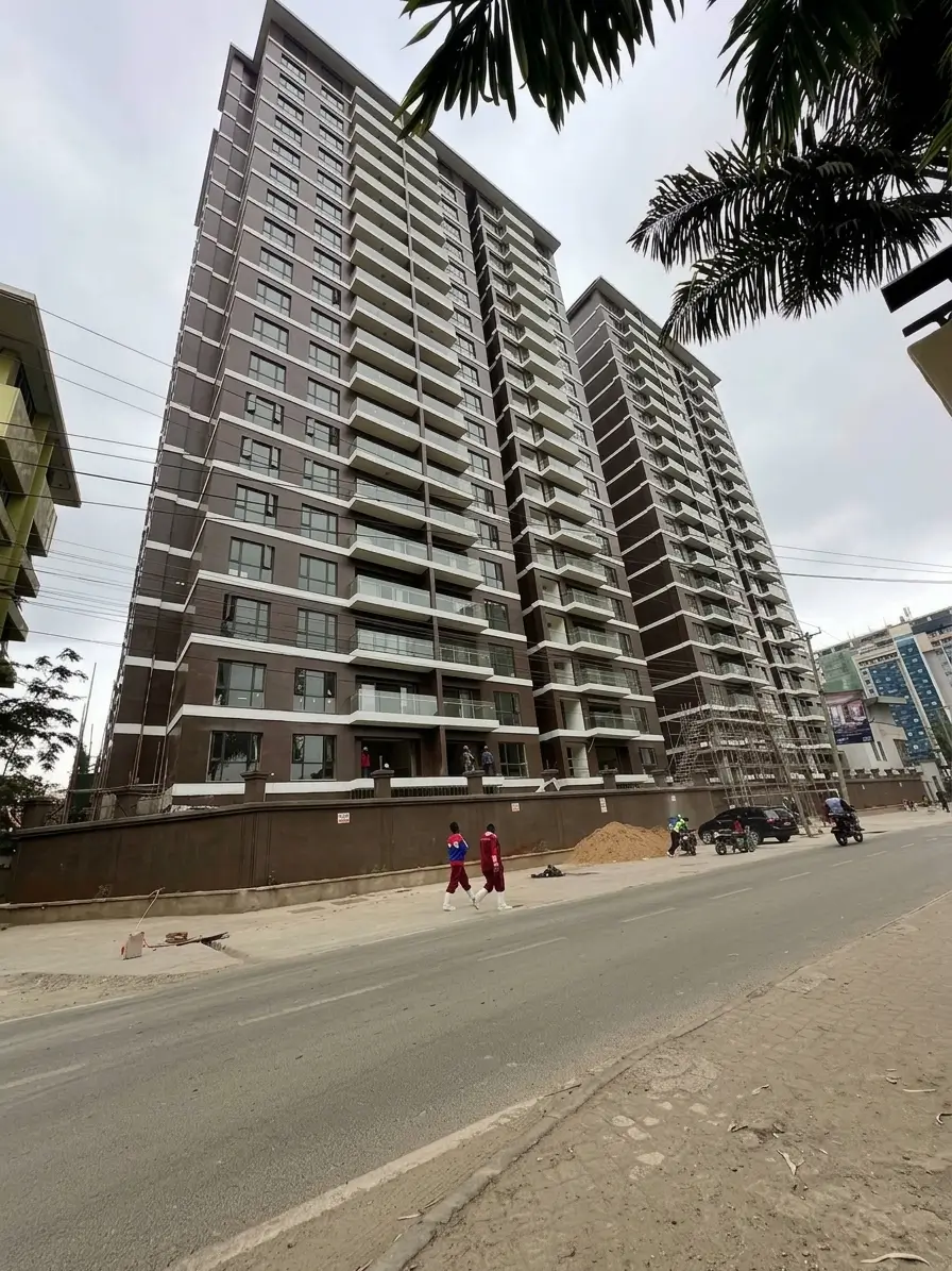 Tall modern high-rise apartment block, street-level view