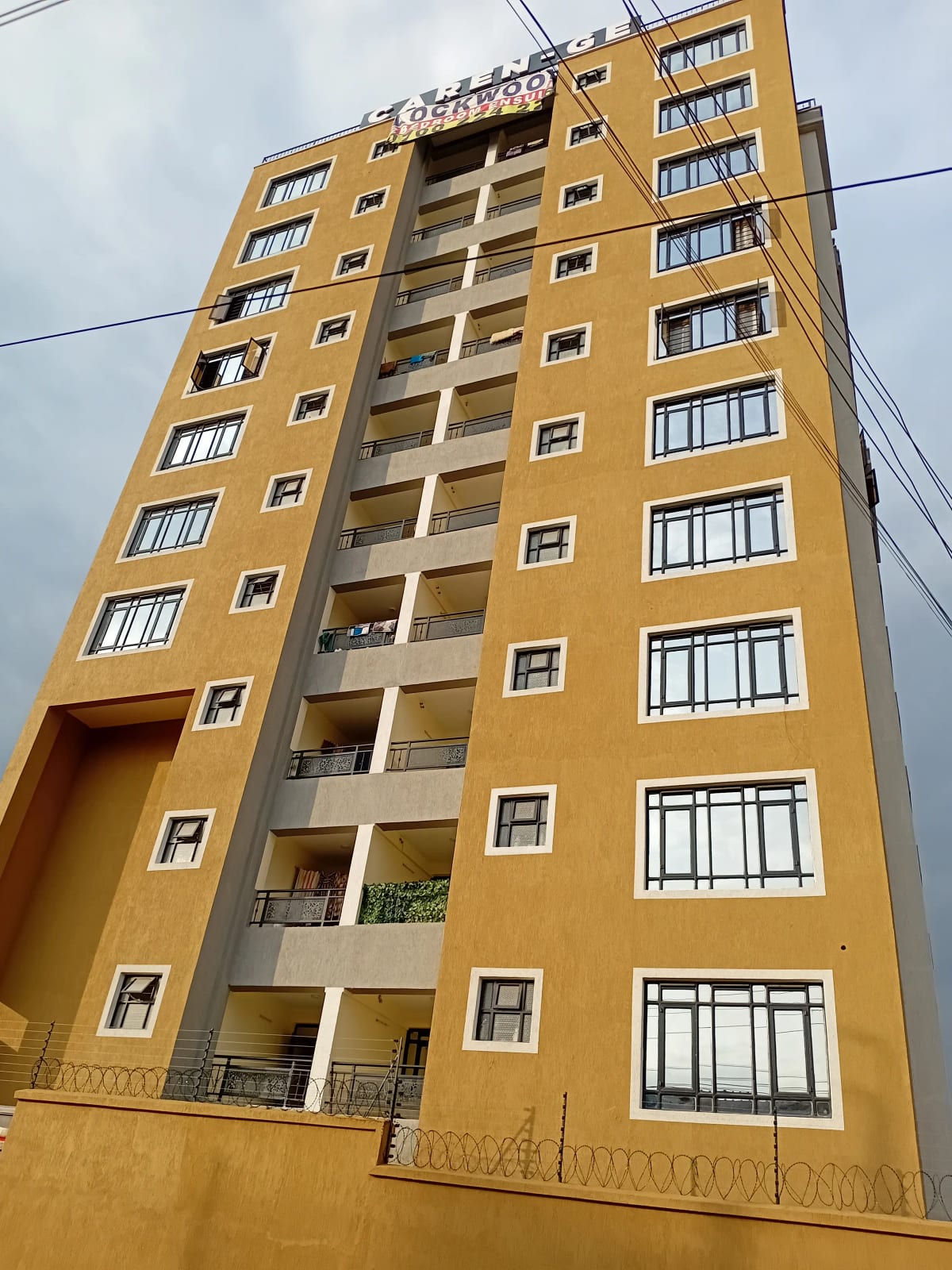 Yellow multi-story residential building with balconies and windows