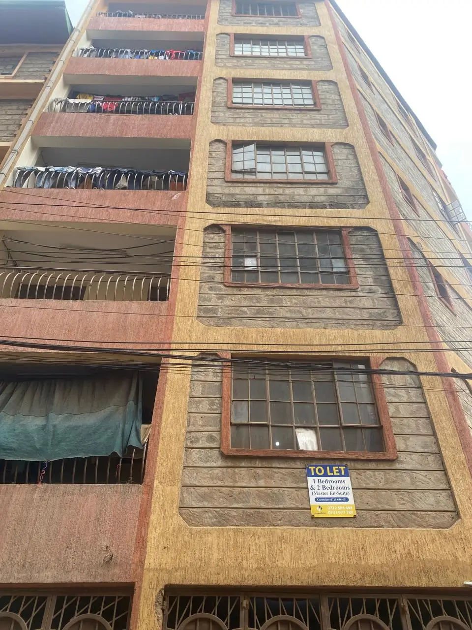 Multi-story residential building facade with balconies and clotheslines