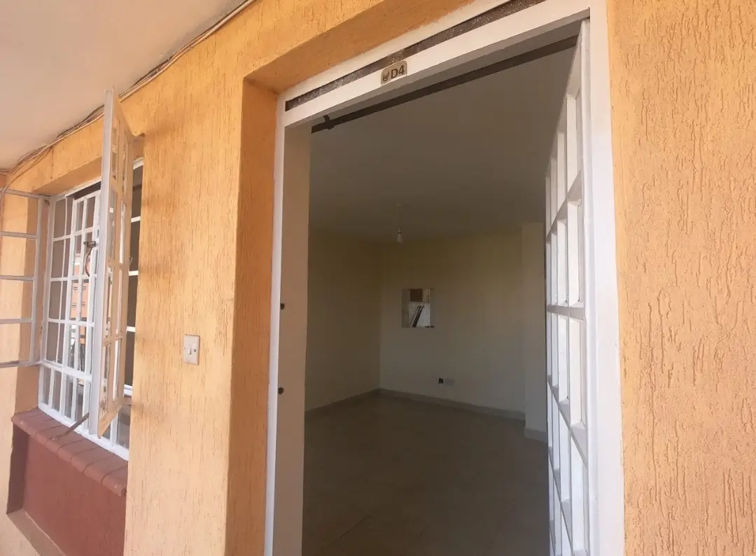 Building entrance hallway with white door frame and orange walls