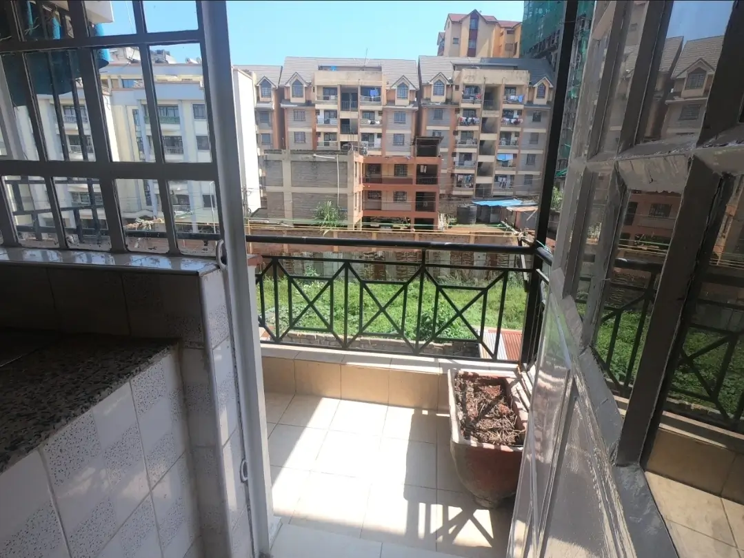 Balcony with city views overlooking residential apartment blocks