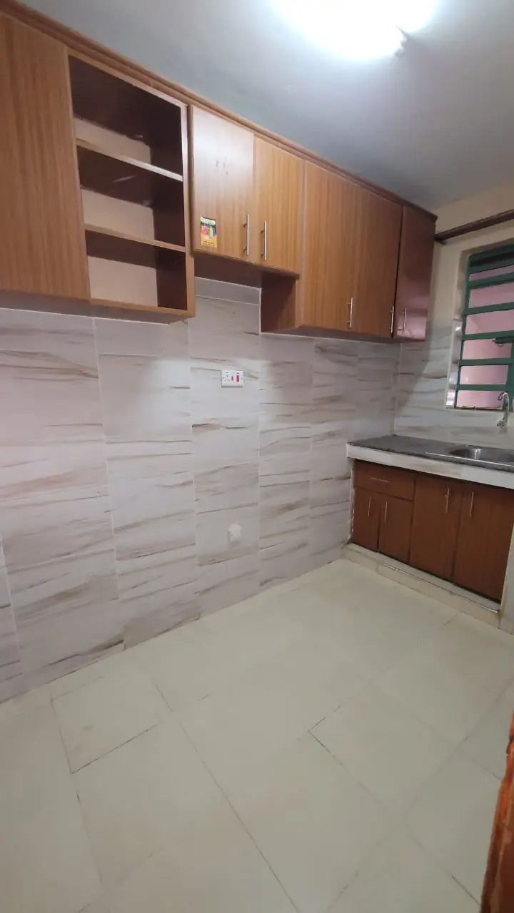 Modern kitchen with wood cabinetry and tiled backsplash