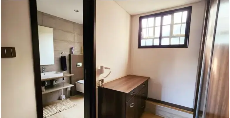 Bedroom with en-suite bathroom visible through open door