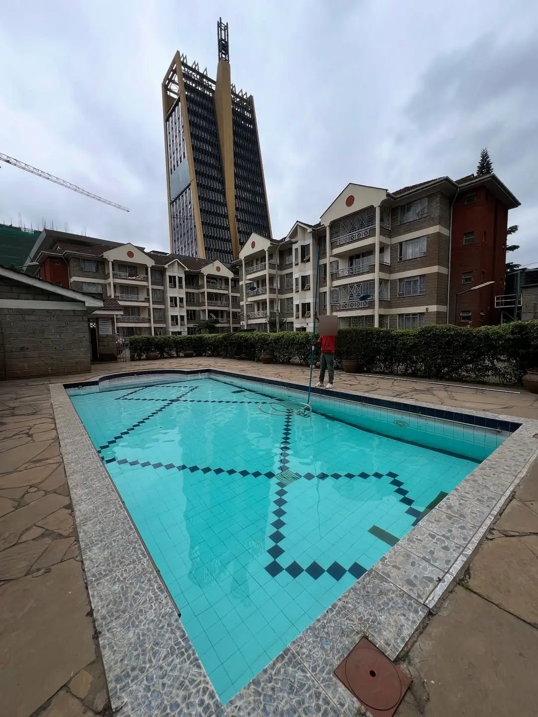 Olympic-sized swimming pool with lane markings, residential compound.