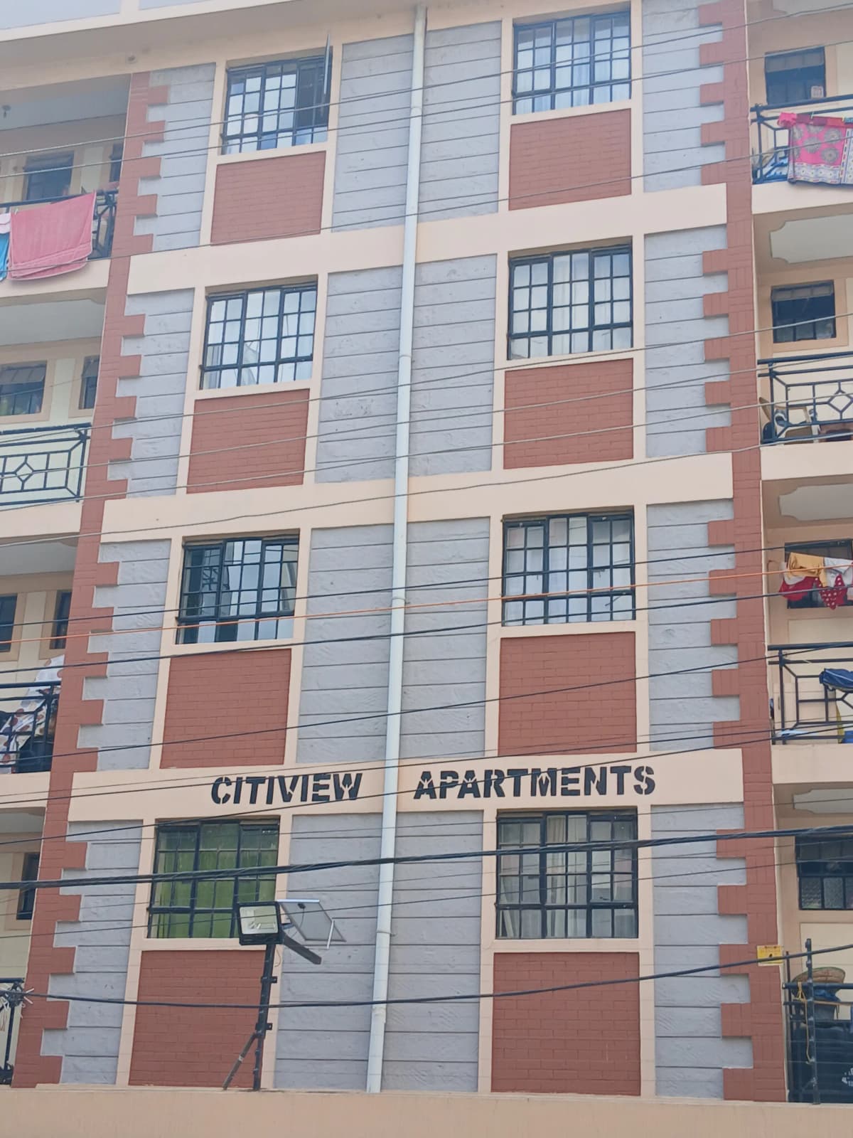 Modern apartment building facade with alternating brick and panel design