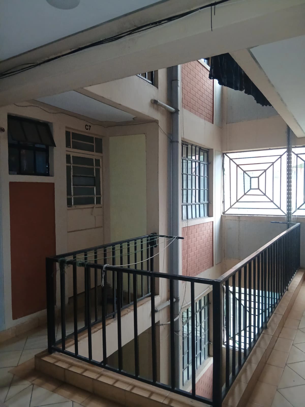 Building corridor with stairwell and metal railings