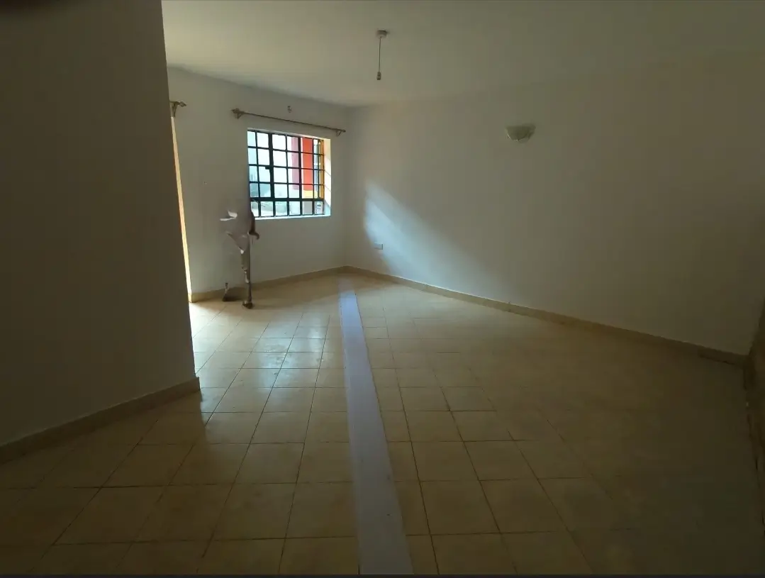 Spacious unfurnished living area with natural light from window