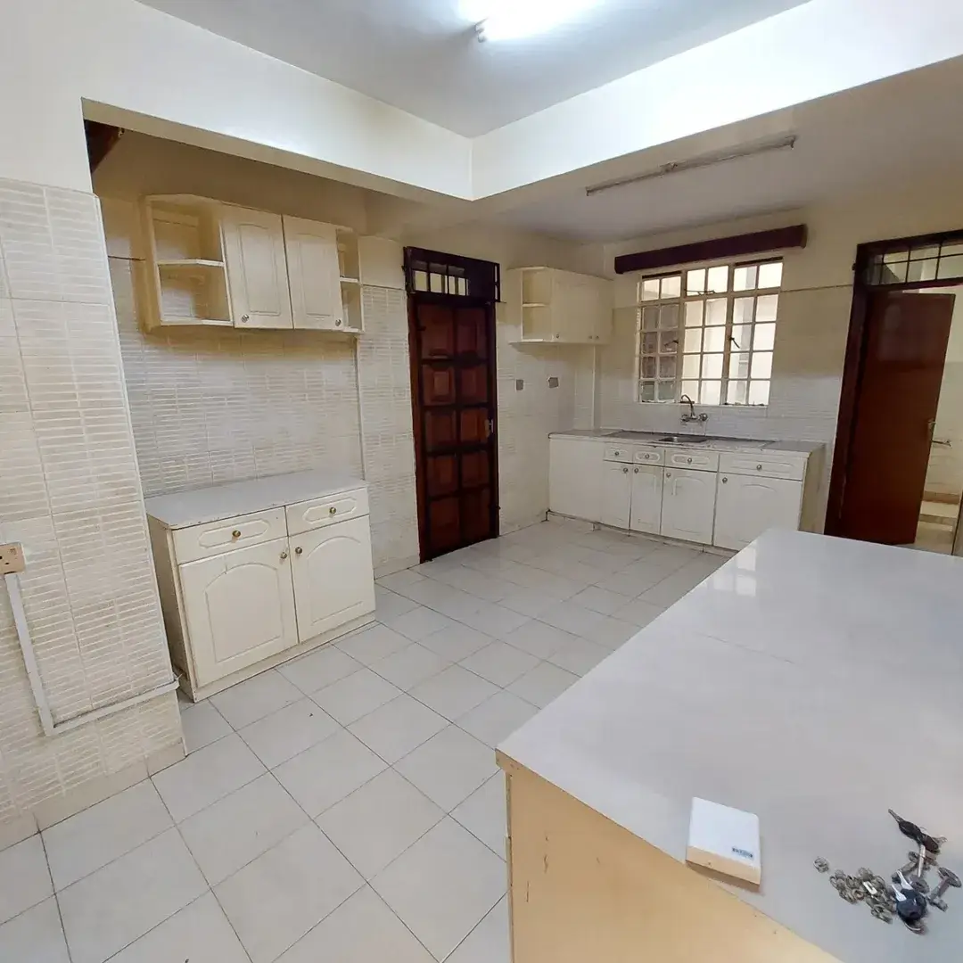 Spacious kitchen with white cabinetry and central island