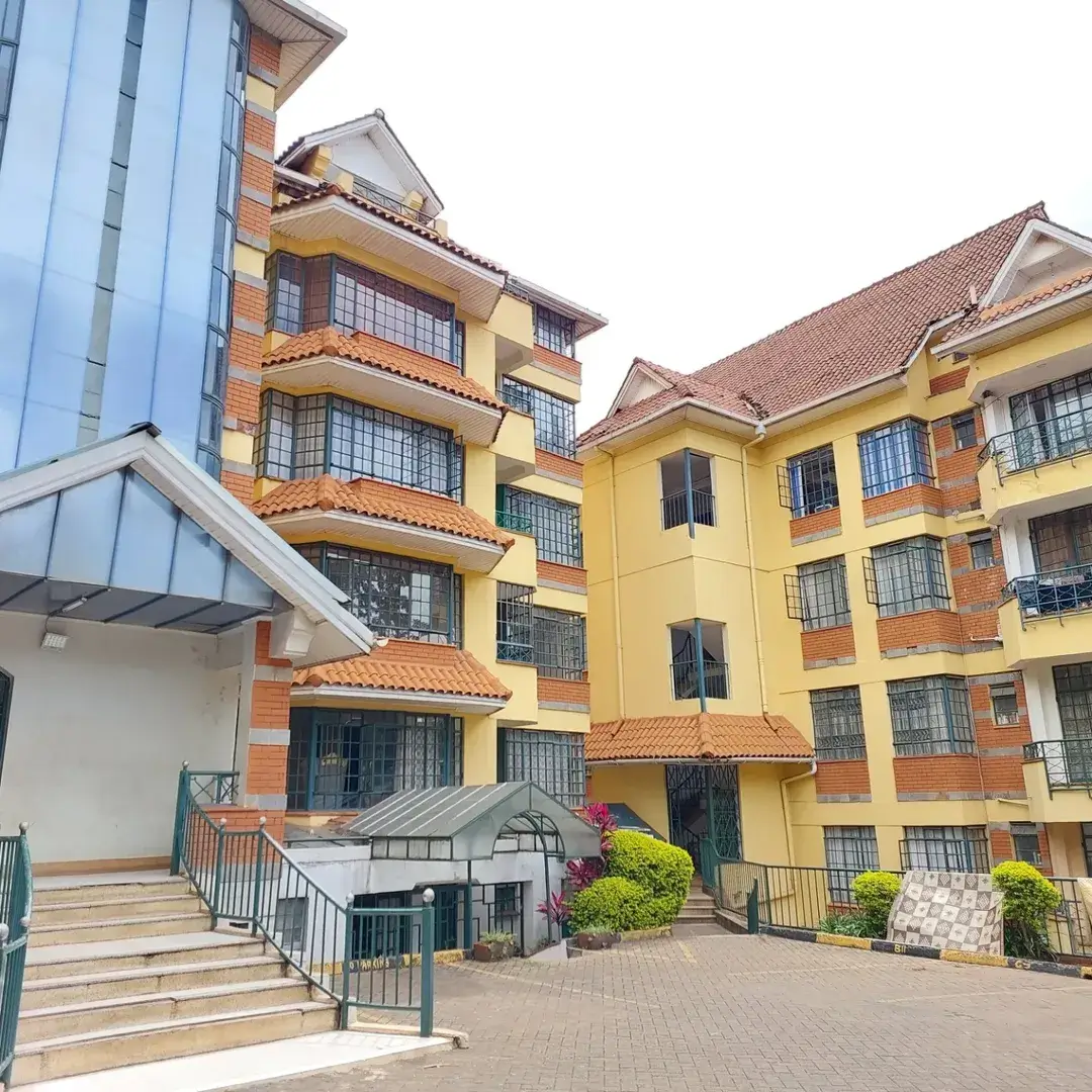 Multi-story residential building with yellow and terracotta facade