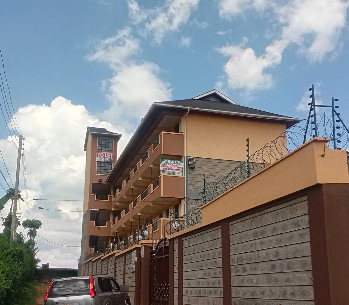 Multi-story residential building with secure perimeter fence