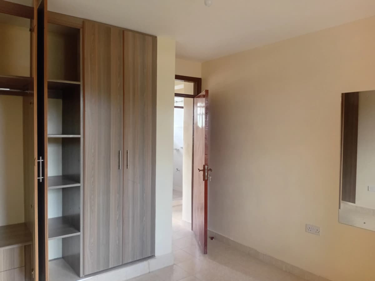 Spacious bedroom with built-in wardrobe and natural light