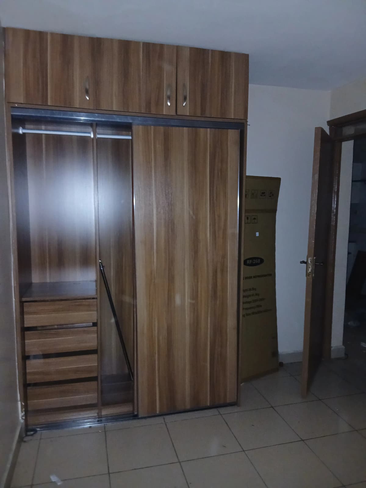 Bedroom with built-in wooden wardrobe and mirrored sliding doors