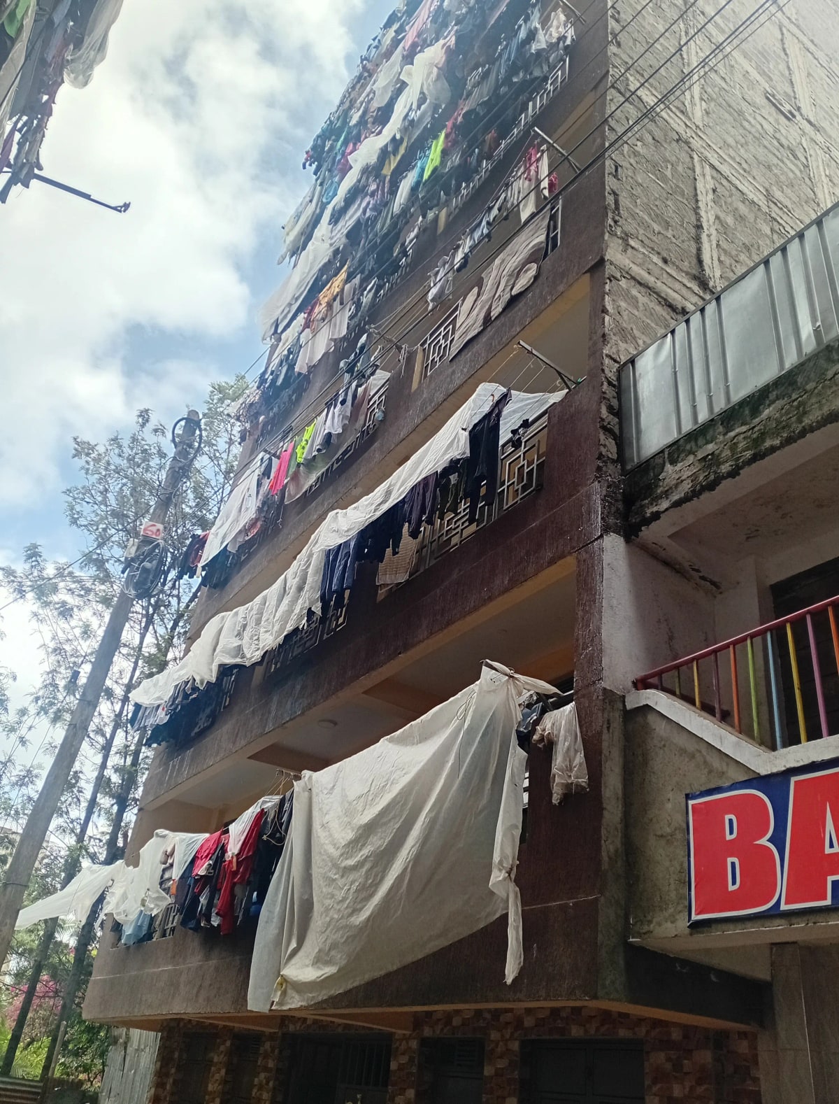 Multi-story residential building facade with laundry drying