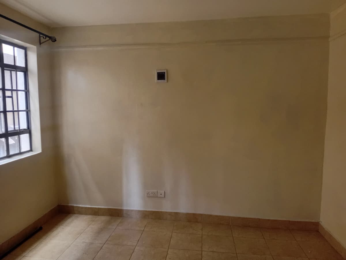 Empty bedroom with tiled floor and single window