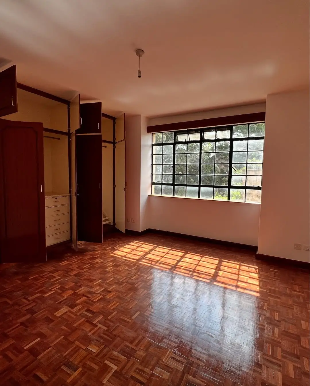 Spacious bedroom with built-in wardrobes and natural light
