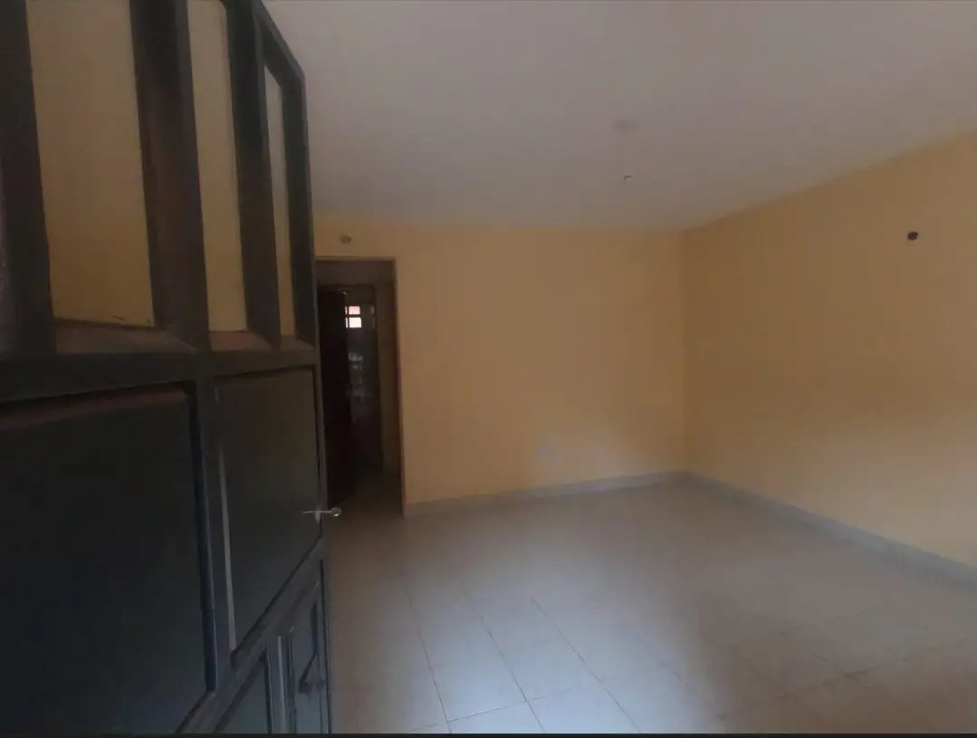 Empty living room with cream walls and dark partition