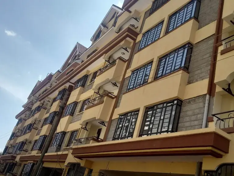 Multi-story residential building facade with yellow walls