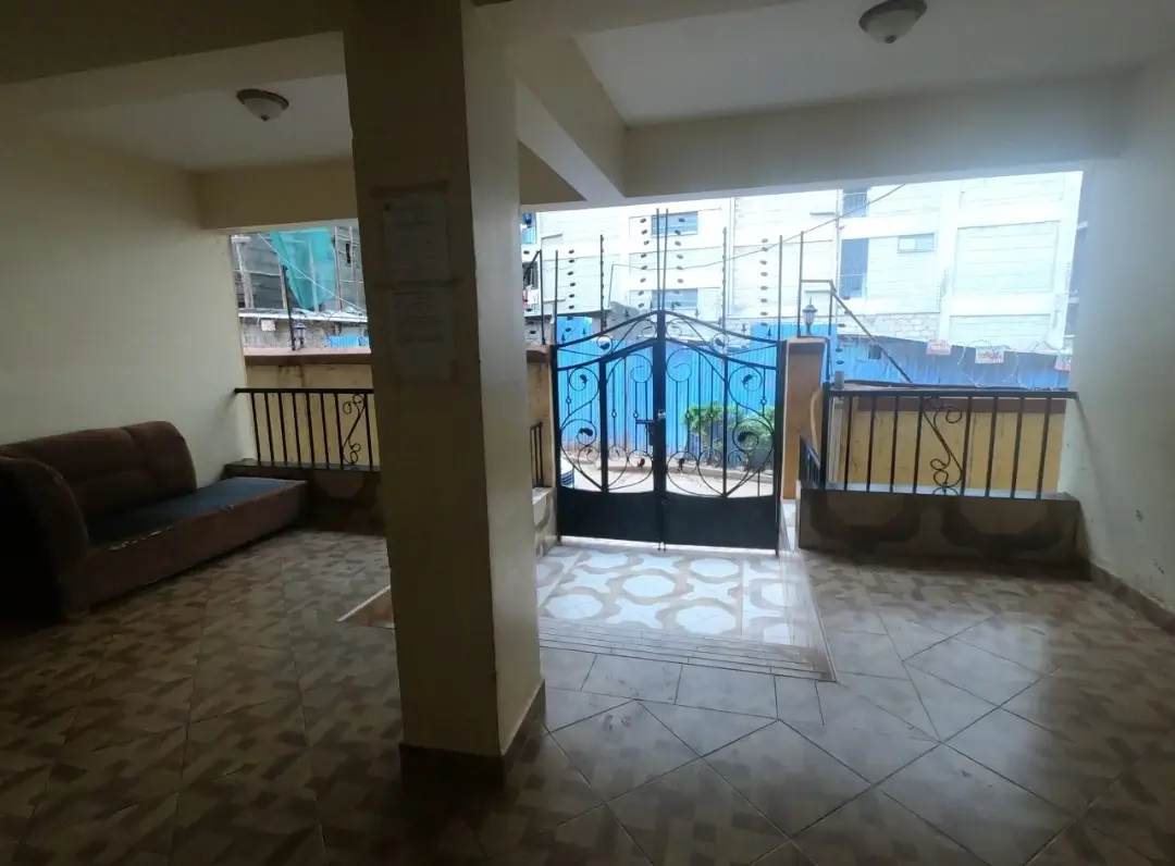 Open-plan living room with direct balcony access and city views