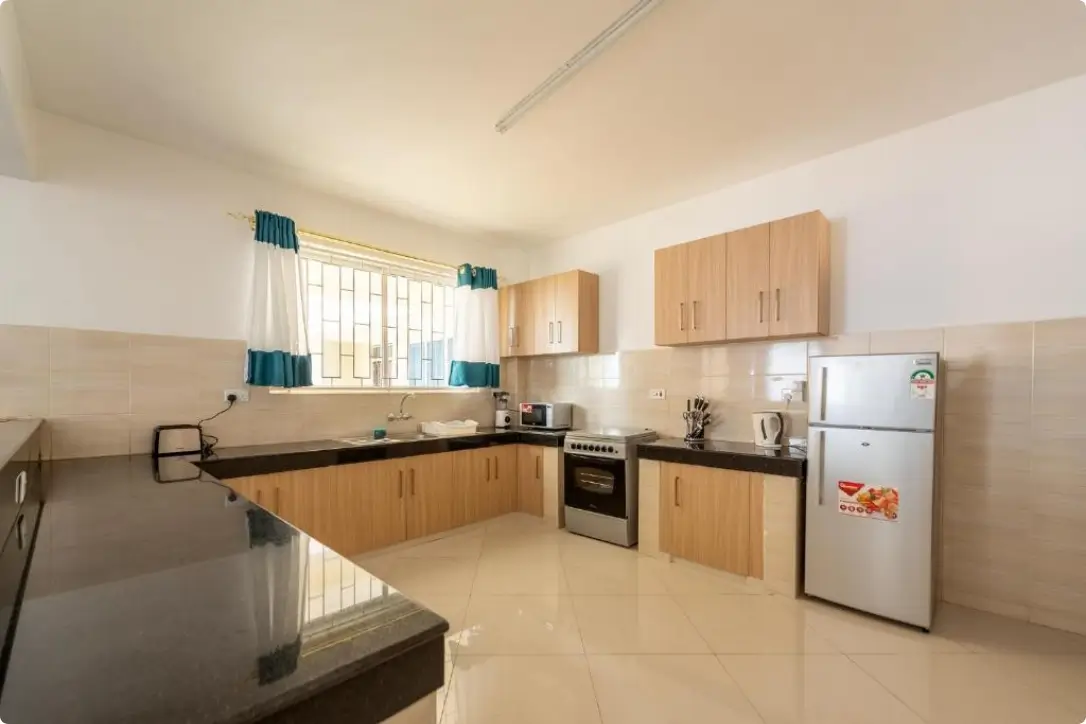 Spacious kitchen with wooden cabinets and stainless steel appliances