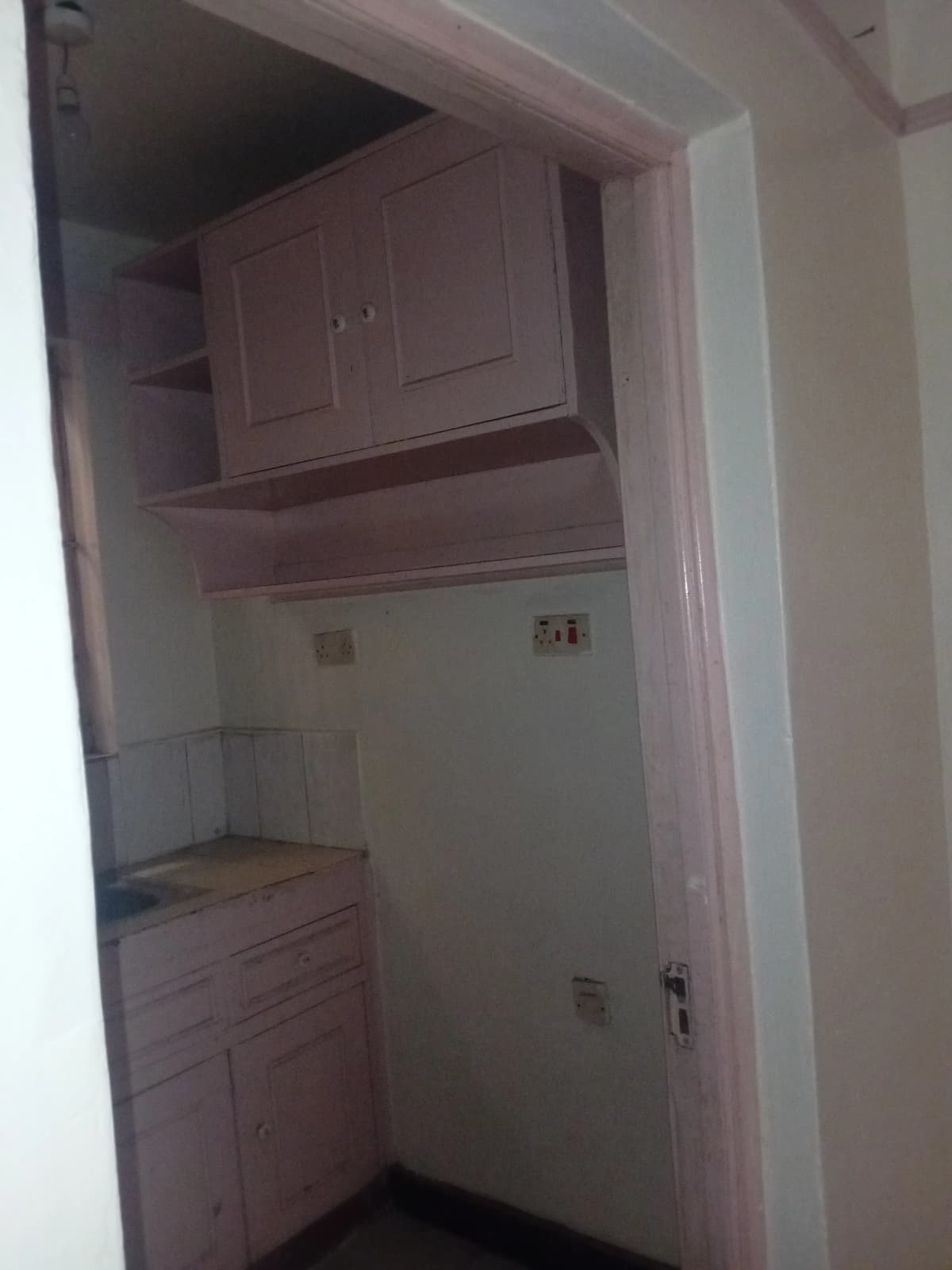 Compact pantry with cabinetry and wall outlets