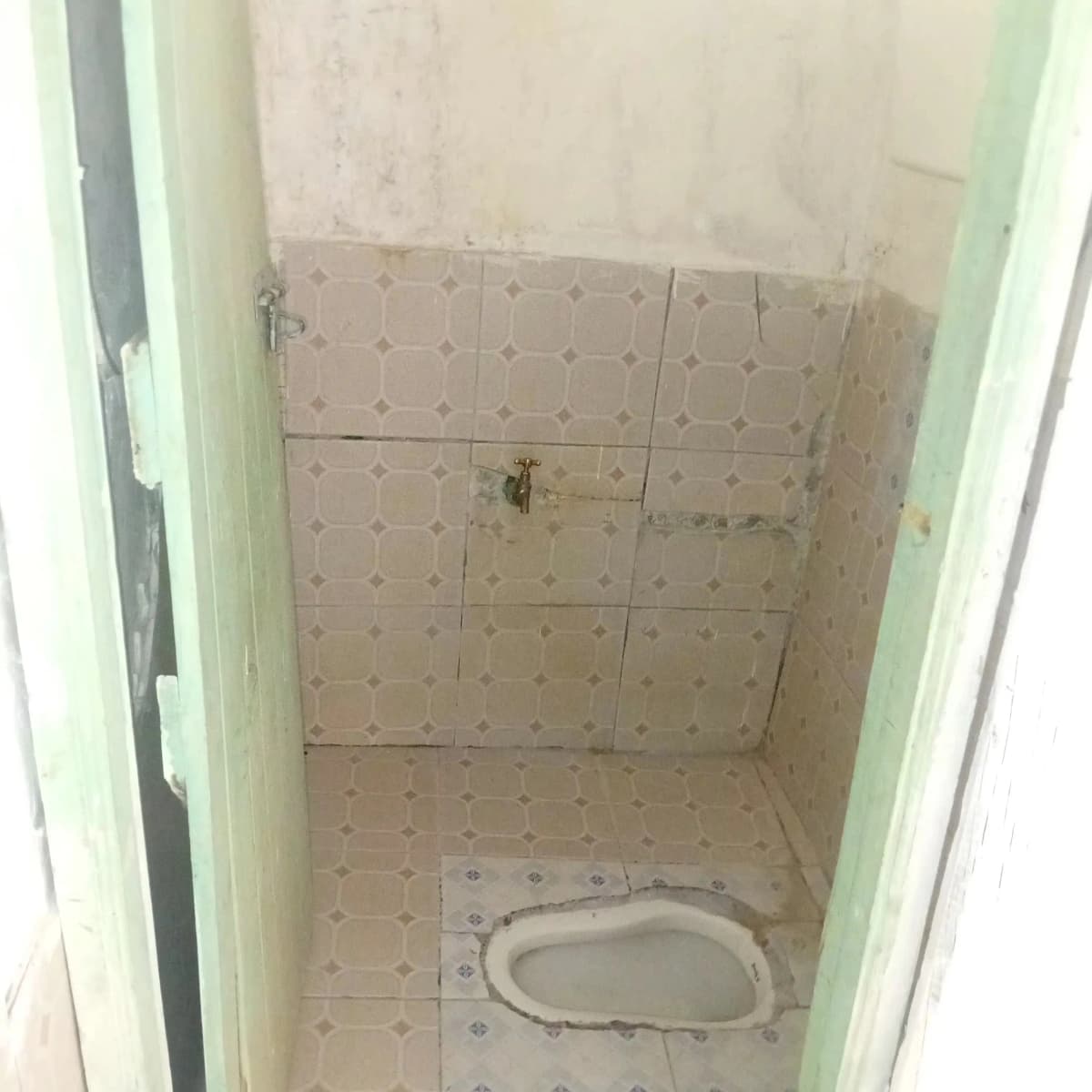 Bathroom under construction with tiled walls and floor fixtures