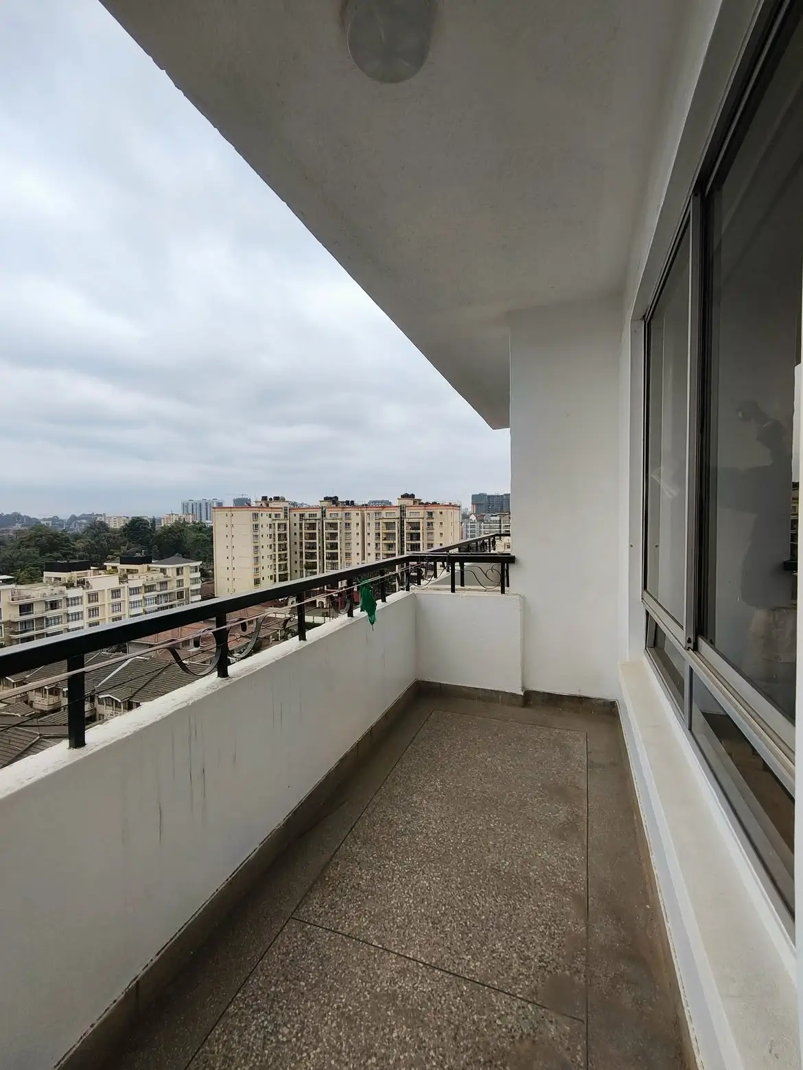 Spacious high-floor balcony overlooking Nairobi cityscape