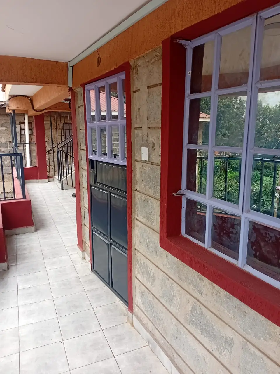 Bright corridor with red walls and large window views
