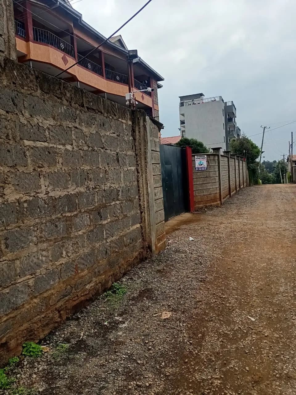 Residential compound with stone walls and metal gates