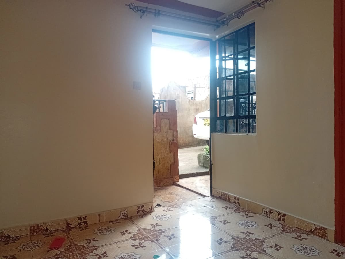 Empty corridor with open door and blue window frame