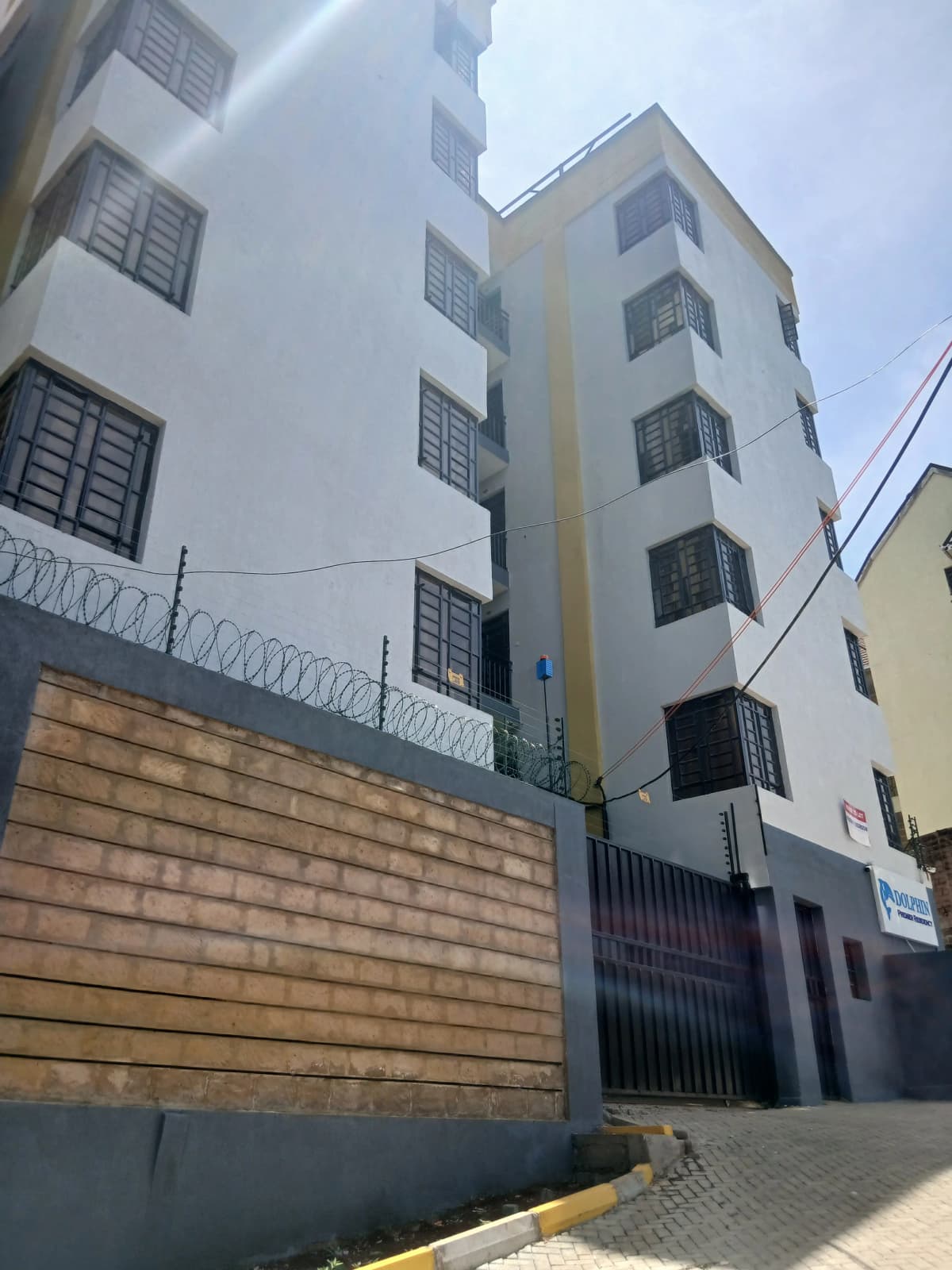 Multi-story residential building facade with perimeter wall