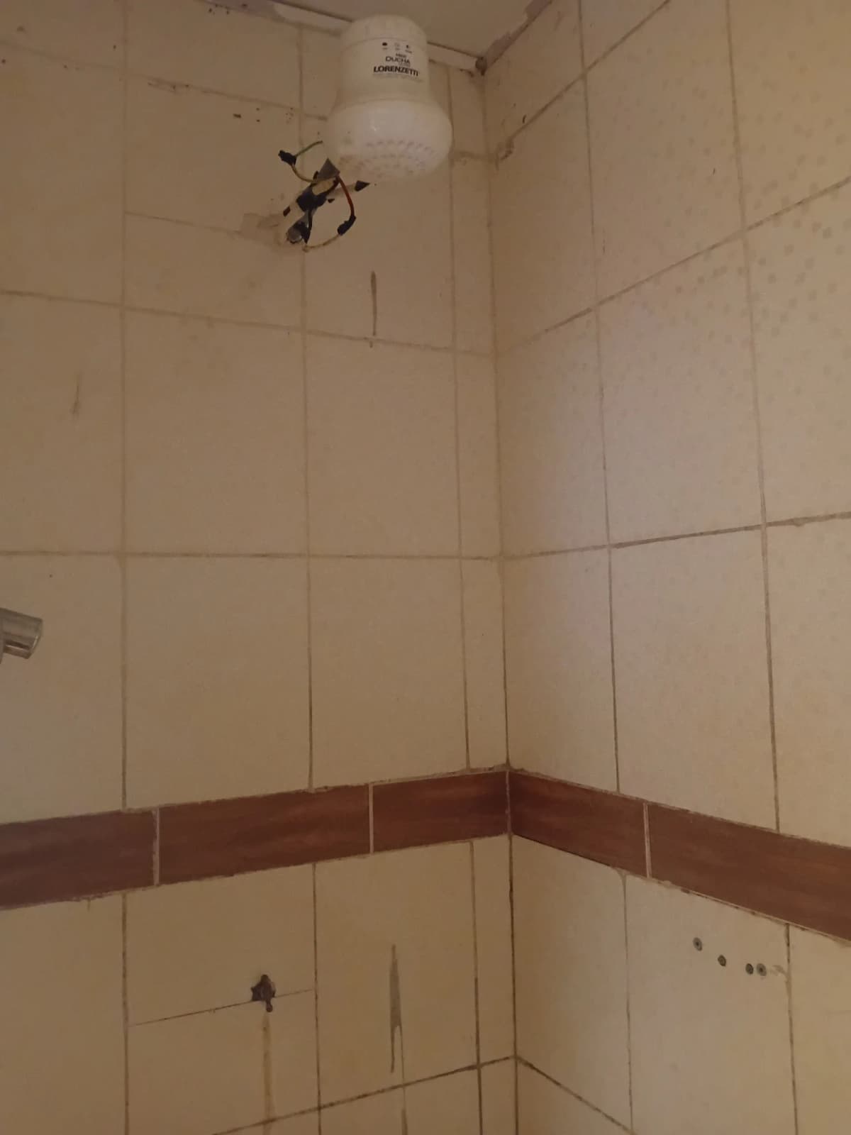 Tiled bathroom with two-tone walls and ceiling fixture