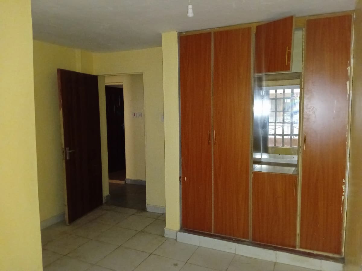 Bedroom with large wooden wardrobe and yellow walls