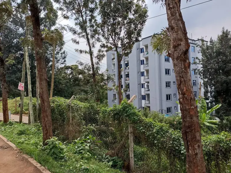 Residential apartment building with lush green compound grounds