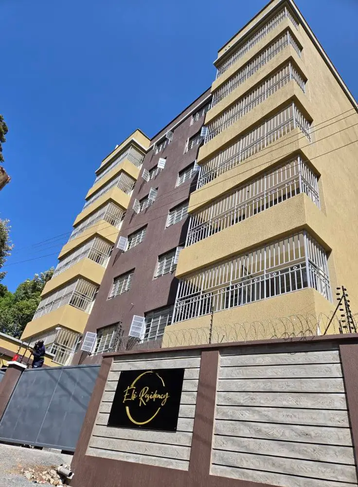 Multi-story residential building facade with balconies and gate